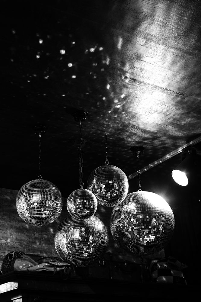 Disco balls hanging in a dark room